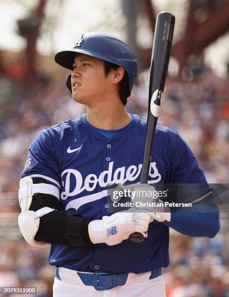 Shohei Ohtani of the Los Angeles Dodgers bats against the San Francisco Giants during the fifth inning of the MLB spring game at Camelback Ranch on...