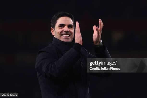 Mikel Arteta, Manager of Arsenal, applauds the fans after victory in the penalty shoot out at full-time following the UEFA Champions League 2023/24...