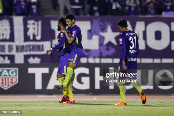 Patric of Sanfrecce Hiroshima celebrates with teammates Hiroki Mizumoto and Teerasil Dangda after scoring the team's third goal during the J.League...