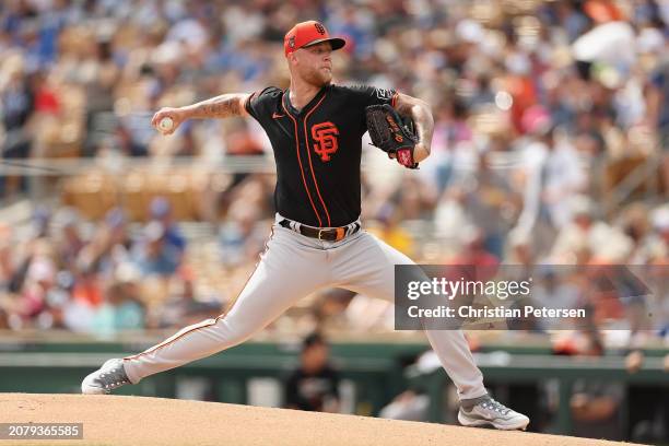 Starting pitcher Blayne Enlow of the San Francisco Giants pitches against the Los Angeles Dodgers during the first inning of the MLB spring game at...