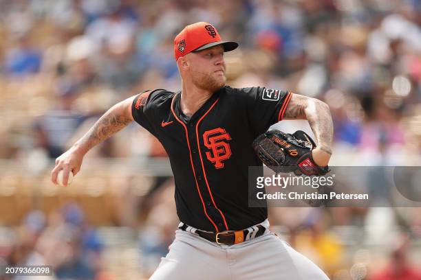 Starting pitcher Blayne Enlow of the San Francisco Giants pitches against the Los Angeles Dodgers during the first inning of the MLB spring game at...
