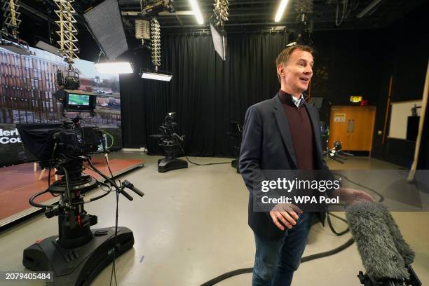 British Chancellor Jeremy Hunt speaks to media during a visit to support a multimillion-pound project to develop one of Europe's largest film-making...