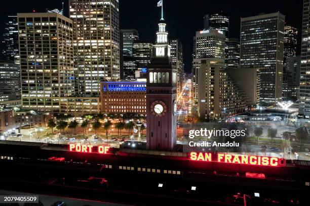 An aerial night view of Ferry Building and buildings in San Francisco, California, United States on March 15, 2024.