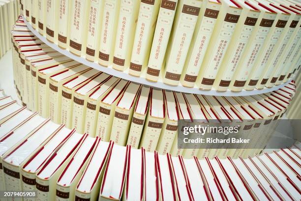 Copies of Chinese General Secretary Xi Jinping's 'The Governance of China' are displayed in the Simplified Chinese alphabet at the London Book Fair...