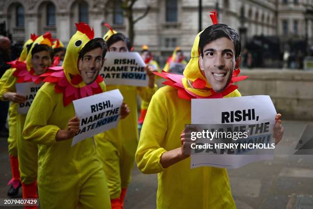 Activists from Britain's main opposition Labour Party pose for a photograph dressed in chicken suits wearing masks of Britain's Prime Minister Rishi...