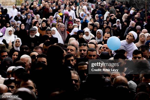 Muslims leave the Al-Aqsa mosque after praying in the first Friday of Ramadan on March 15, 2024 in Jerusalem. Palestinians and Israelis are bracing...