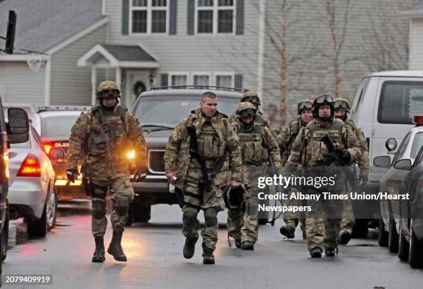 Memeber of the State Police and Warren County Sheriffs Emergency Response Team leave the scene of a stand off on Boylston St. After suspect...