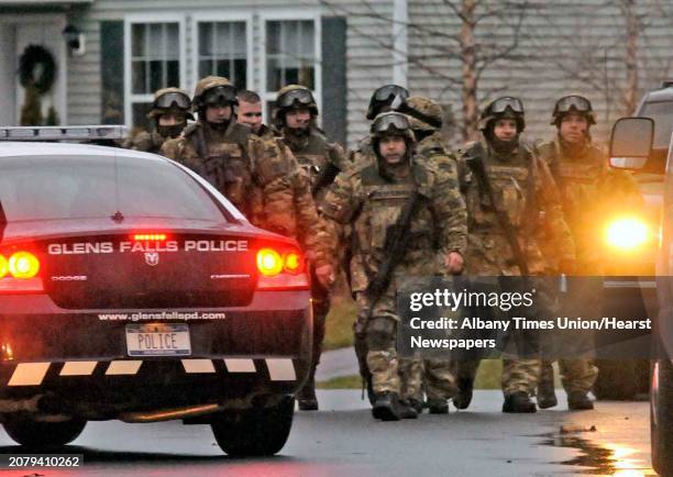Memebers of the State Police and Warren County Sheriffs Emergency Response Team leave the scene of a stand off on Boylston St. After suspect...