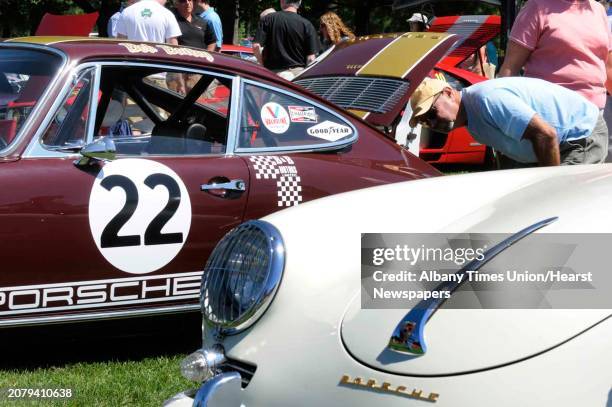 Rick Gifford of Malta checks out the engine of a 1968 Porsche 911 during the Hemmings 5th Annual Sports & Exotic Car Show at the Saratoga Automobile...