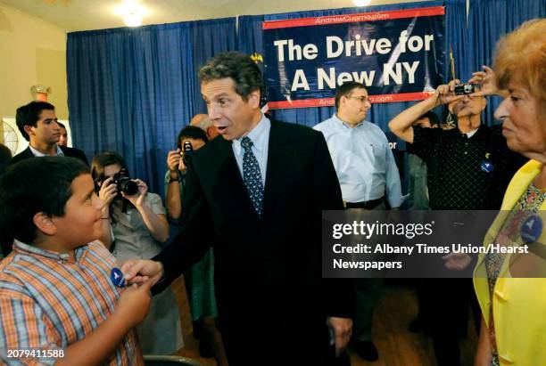 New York State Attorney General and Democratic candidate for governor Andrew Cuomo asks in a joking manner "whose that on the pin" as he greets young...