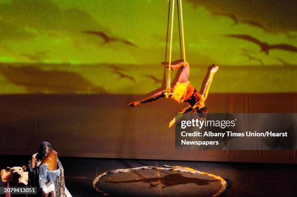 Lady Moon plays the autoharp as C.Ryder Cooley flys through the air during Cooley's production of XMALIA Songs About Extinction at Proctors Theater...