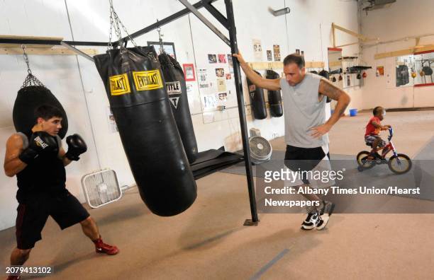 Boxer Javy Martinez,left, works out with trainer Kyle Provenzano at Schott's Gym in Albany, NY Tuesday July 12,2011.