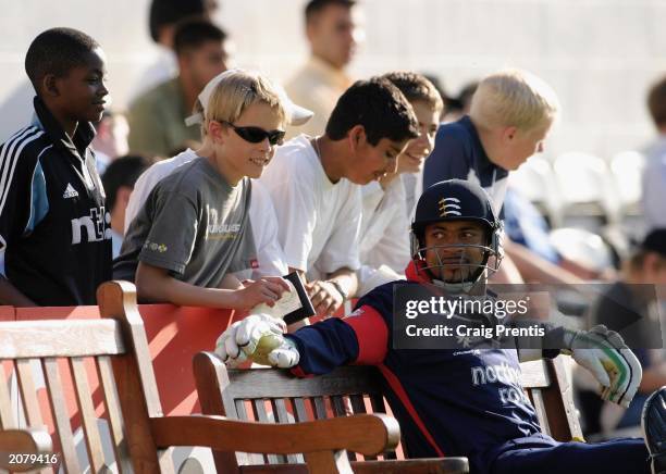 Young cricket fans keep a close watch as David Alleyne of Middlesex prepares to go in to bat during the first day of the Twenty20 Cup match between...