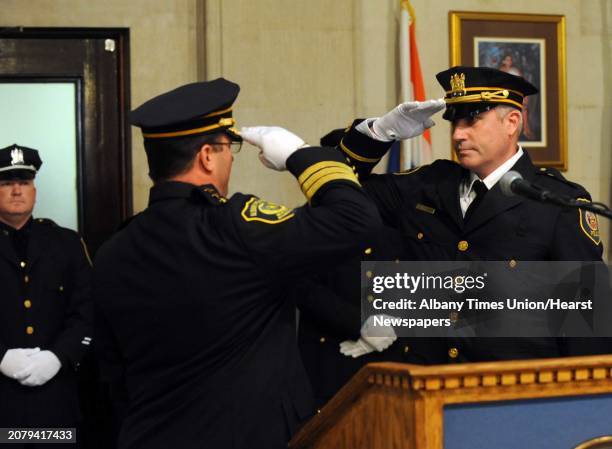 Police Chief Steve Krokoff salutes newly promoted Lieutenant James Gallagher during a promotion ceremony at City Hall in Albany, NY Friday Oct. 12,...