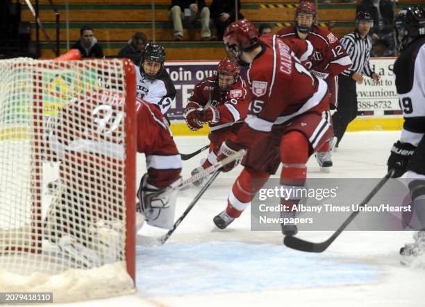 Harvard goalie Raphael Girard makes a save on Union's Daniel Ciampini during their men's college ECAC hockey game on Tuesday Jan. 22 in Schenectady,...