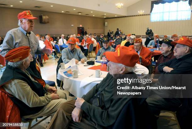 Battle of Iwo Jima veteran Jim Smith, left, of Greenfield Center tells a battle story as he is recognized during a ceremony to remember those who...