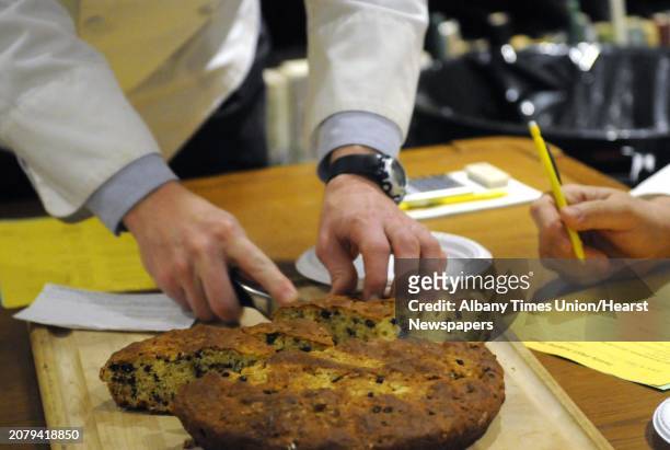 Chef Michael Kiernan slices up a soda bread during judging of the Irish Soda Bread Amateur Competition at the Irish American Heritage Museum on...