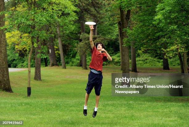 Armando Spring leaps into the air to grab a Frisbee while playing with friend Colin Kennedy at Central Park on Thursday May 23, 2013 in Schenectady,...