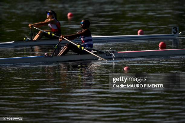 Peru's Adriana Maria Velasco and Cuba's Yariulvis Cobas Garcia compete during the Women's Single Sculls W1x repechage of the Americas Olympic and...