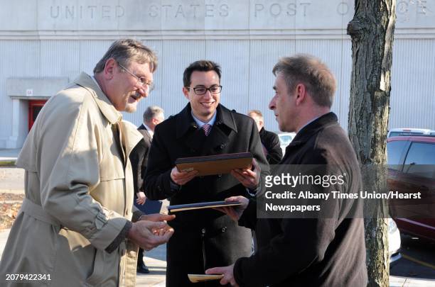 Postal employee and Army veteran, Gerald Cahill, right a supervisor at the Waterford Post Office, recieves certificates of recognition from David J....