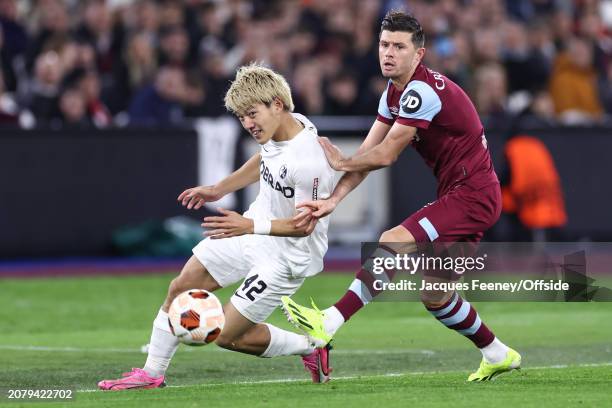 Ritsu Doan of Freiburg and Aaron Cresswell of West Ham during the UEFA Europa League 2023/24 round of 16 second leg match between West Ham United FC...