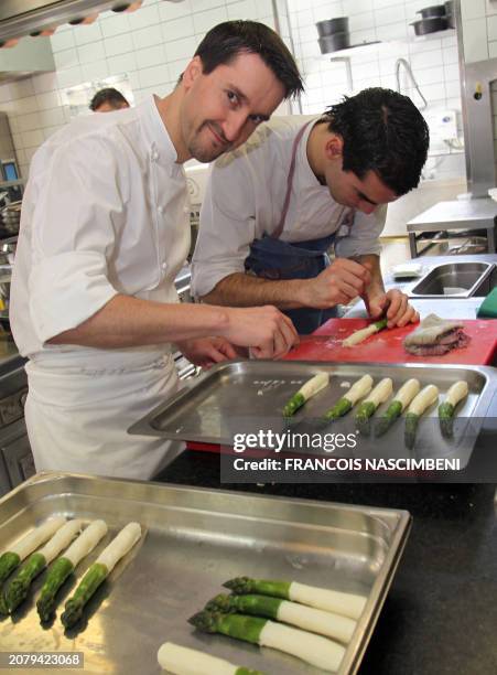 French new chef of the restaurant "Les Crayeres", Philippe Mille prepares asparagus on May 20, 2010 in the kitchen of the restaurant in Reims,...