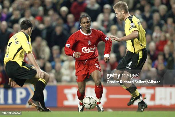 January 10: Florent Sinama-Pongolle of Liverpool and Olof Mellberg of Aston Villa challenge during the Premier League match between Liverpool and...