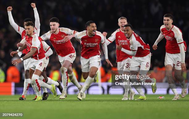 The players of Arsenal celebrate as David Raya of Arsenal makes the match-winning save from the fourth penalty from Galeno of FC Porto in the penalty...