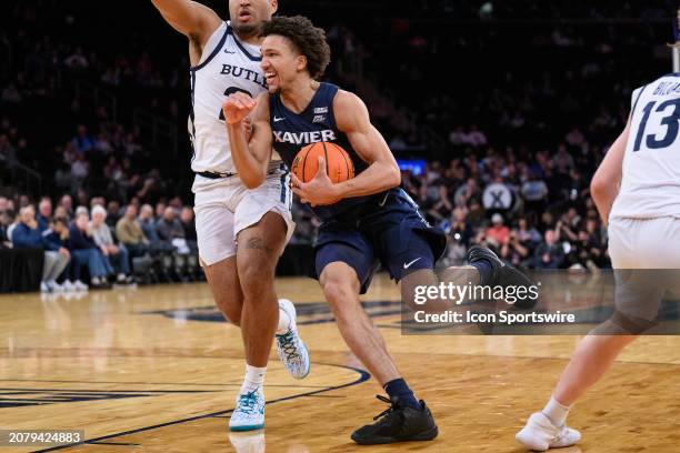 Xavier Musketeers guard Desmond Claude drives to the basket against Butler Bulldogs guard Pierre Brooks II during the Big East Tournament men's...