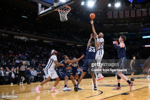 Butler Bulldogs center Jalen Thomas shoots over Xavier Musketeers forward Abou Ousmane in the lane during the Big East Tournament men's college...