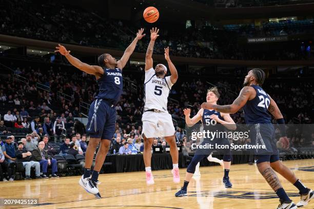 Butler Bulldogs guard Posh Alexander shoots over Xavier Musketeers guard Quincy Olivari during the Big East Tournament men's college basketball game...