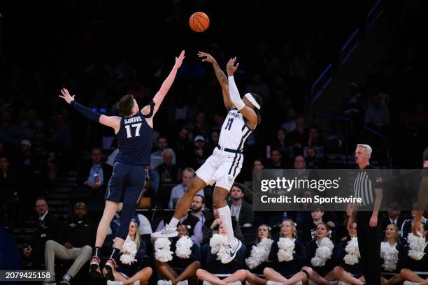 Butler Bulldogs forward Jahmyl Telfort shoots over Xavier Musketeers forward Lazar Djokovic during the Big East Tournament men's college basketball...