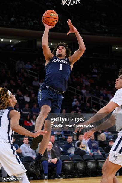 Xavier Musketeers guard Desmond Claude drives in for a layup during the Big East Tournament men's college basketball game between the Butler Bulldogs...