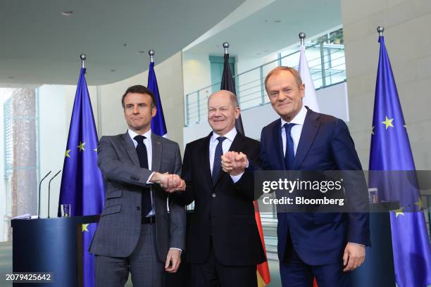 Emmanuel Macron, France's president, left, Olaf Scholz, Germany's chancellor, and Donald Tusk, Poland's prime minister, right, during a joint press...