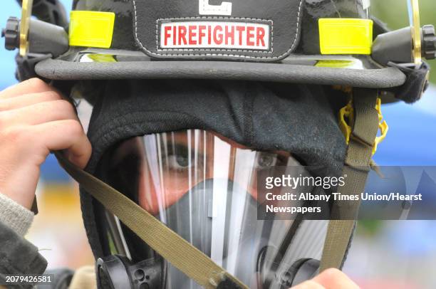 Seventeen-year-old Ryan Yattaw of Glenville suits up for a drill as one hundred Fire Department Explorers and Junior Firefighters from across New...