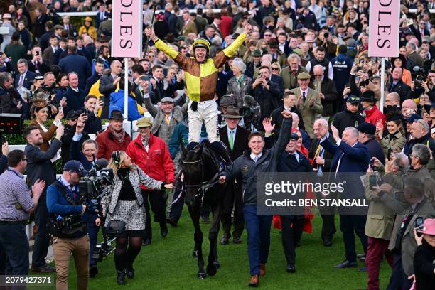 Jockey Paul Townend celebrates as he arrives in the winner's enclosure after riding Galopin Des Champs to victory in the Cheltenham Gold Cup...