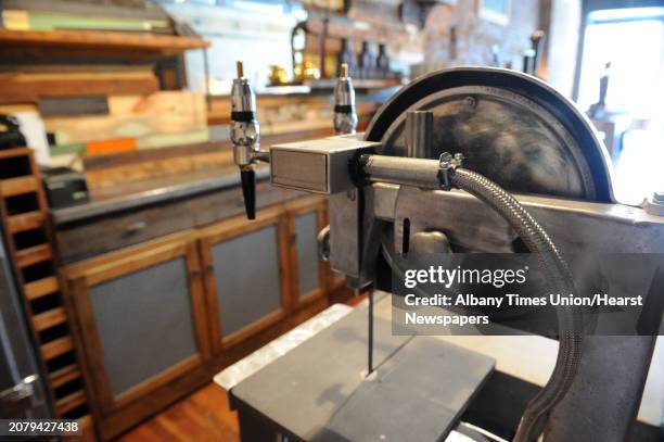 An antique saw converted into draft pulls at Kevin Blodgett's new bar called The Shop on Friday Oct. 10, 2014 in Troy, N.Y. A 35,000-square-foot Troy...