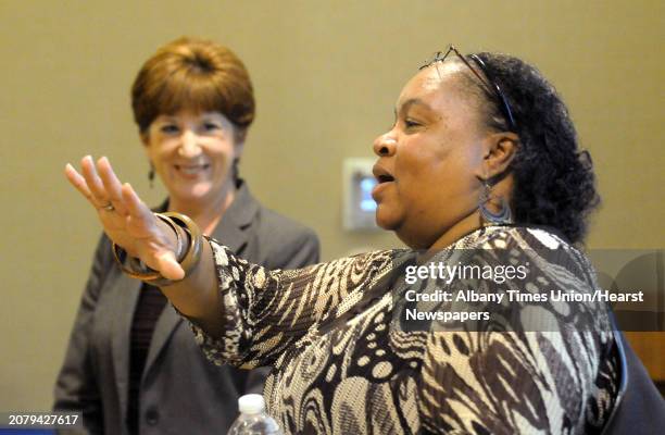 City Councilmember Ward 2 Vivian Kornegay, calms down a loud crowd as Mayor Kathy Sheehan talks about the City's budget during a town hall meeting at...
