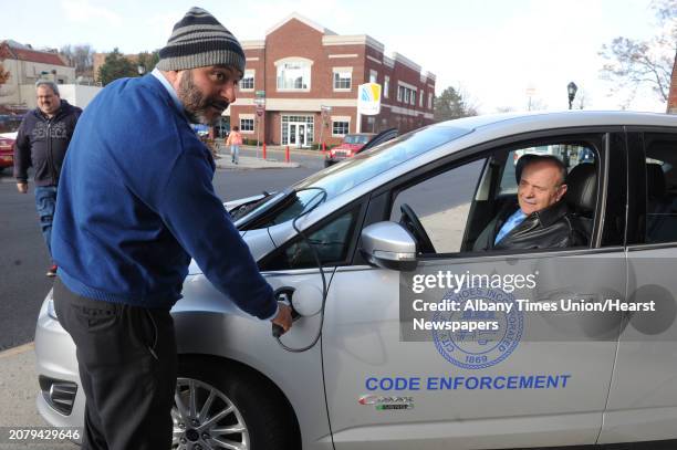 Treasurer Peter Frangie, left, and Cohoes Mayor George Primeau check out the new vehicles during the announcement of the acquisition of the 2 Ford...