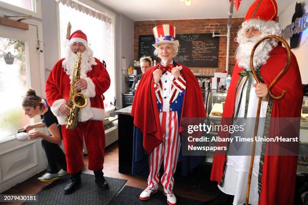 Luke Sax-O-Clausâ McNamee, left, Uncle Sam Fred Polnisch and Sinterklass a.k.a. St. Nicholas Karl Felsen visit Sweet Sue's on Friday Dec. 19, 2014...