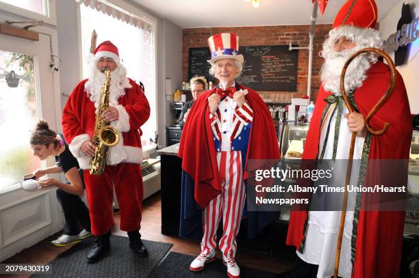 Luke Sax-O-Clausâ McNamee, left, Uncle Sam Fred Polnisch and Sinterklass a.k.a. St. Nicholas Karl Felsen visit Sweet Sue's on Friday Dec. 19, 2014...