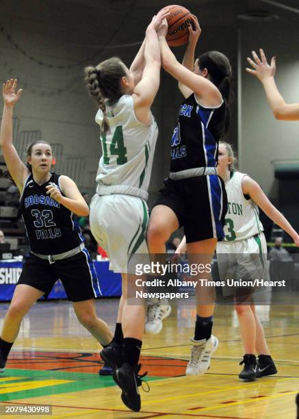 Hoosick Falls Rachel Pine looks to pass to teammate Megan Flynn during their 55-36 win over Irvington in the Class B State Girls' Basketball...