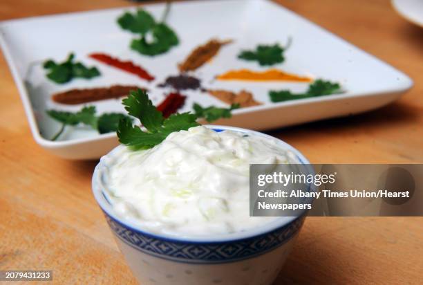 Raita an Indian side dish of yogurt containing chopped cucumber or other vegetables, and spices prepared by Caroline Barrett on Wednesday April 1,...