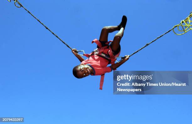 Five-year-old Romario Wright of Albany does a flip on the bungee jump at Funplex Fun Park on Saturday Aug. 8, 2015 in East Greenbush, N.Y.