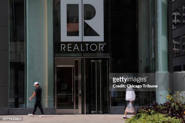People walk past the National Association of Realtors building at 430 N. Michigan Ave. In Chicago on Sept. 20, 2023.