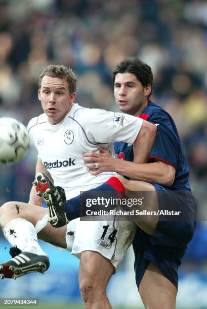 January 17: Kevin Davies of Bolton Wanderers and Dejan Stefanovic of Portsmouth challenge during the Premier League match between Bolton Wanderers...