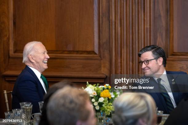 President Joe Biden laughs beside U.S. House Speaker Mike Johnson, during the annual Friends Of Ireland Speaker Luncheon at the U.S. Capitol on March...