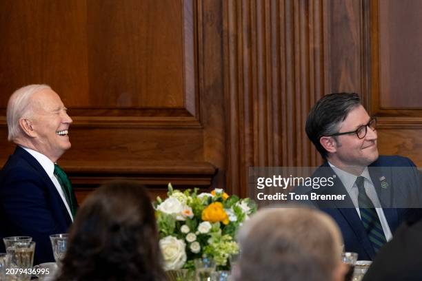President Joe Biden laughs beside U.S. House Speaker Mike Johnson, during the annual Friends Of Ireland Speaker Luncheon at the U.S. Capitol on March...