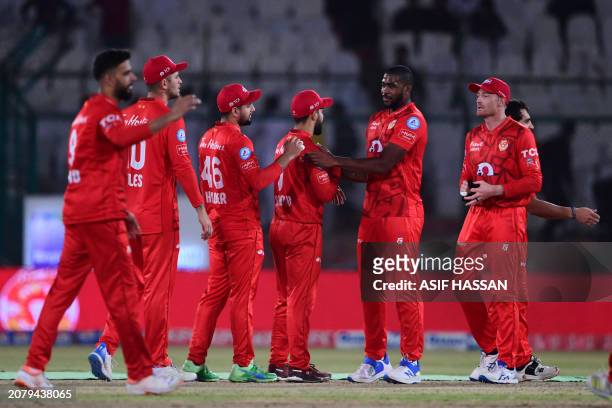 Islamabad United's players celebrate their match victory end of the Pakistan Super League Twenty20 cricket eliminator match between Islamabad United...