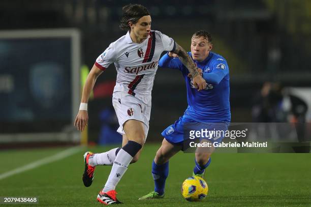 Riccardo Calafiori of Bologna FC battles for the ball with Szymon Zurkoski of Empoli FC during the Serie A TIM match between Empoli FC and Bologna FC...